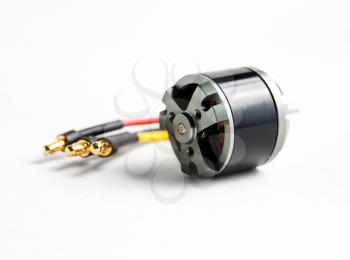 Small electric motor and wires on white background