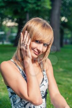 Cute blonde posing in candid style outdoors