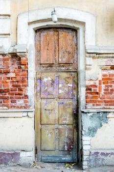 A brown wood old door in the centre of Astrakhan Russia, traditional Russian XIX century design