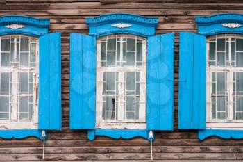 Windows of old, wooden cottage in the countryside. Old Windows in Wooden Frame from a traditional Russian house