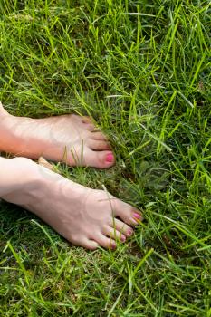 Foot over green grass.