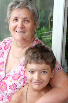 Happy grandmother and grandson together looking at camera