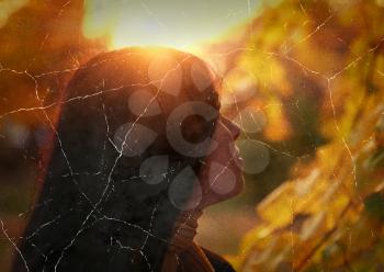 Retro stylized photo young pretty woman in the autumn park profile view backlit by sunset headshot