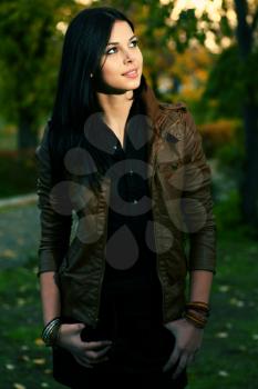 Young attractive girl in autumn park color stylized photo