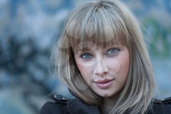 Charming blond haired women headshot against grungy wall