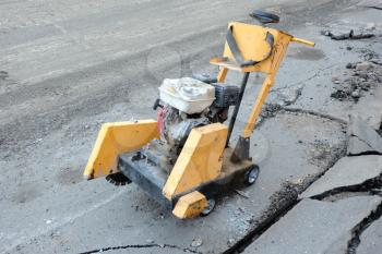 Circular small drill breaking street asphalt,Jackhammer breaking street asphalt, repairing damaged water supply