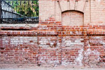 Ancient immured door in the red brick wall.