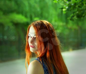 Toned image of pretty women with red hairs outdoors.