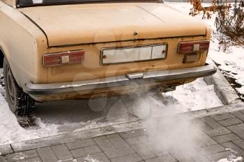 Old car smoking, environmentally dangerous vehicle vintage color-look