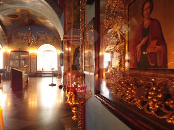 Astrakhan Russia - 10 October 2020: Orthodox church inside with burning oil lamp on golden chains in front of the saint Michael icon