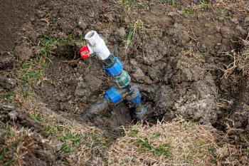 Repair and fixing concept. Busted and broken water pipe in back yard