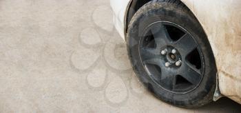 Close-up of metal rim of car wheel. Detail of car with a lot of copyspace on background