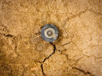 Sprinkler head on dry soil top view. Drought, water lack in arid climat affecting life of millions people all around the word.