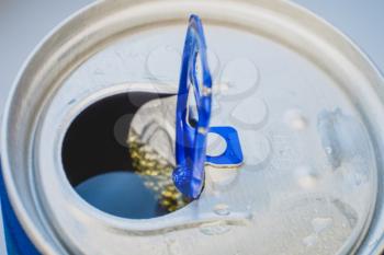 Open aluminium can full of soda, macro of lid