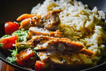 Indian curry spacy food. Chicken breast on basmati rice with vegetables.
