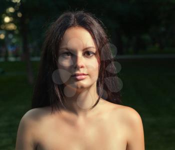 Square picture of a bare shoulders women outdoors