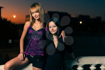 Two girl posing together in a evening