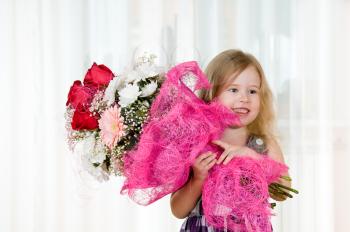 Royalty Free Photo of a Little Girl Holding a Bouquet of Flowers