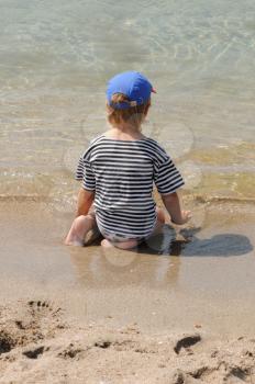 Royalty Free Photo of a Child Sitting on the Beach