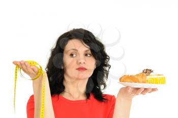 Royalty Free Photo of a Woman Holding Dessert and a Tape Measure