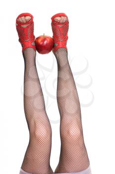 Royalty Free Photo of a Woman Holding an Apple With Her Feet