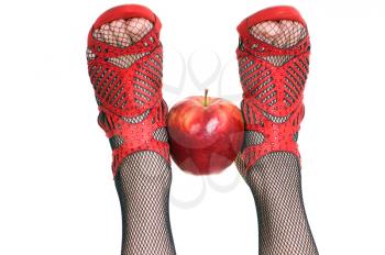 Royalty Free Photo of a Woman Holding an Apple With Her Feet