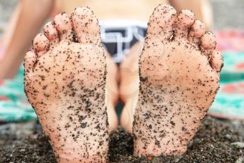Royalty Free Photo of a Person's Feet Covered in Sand