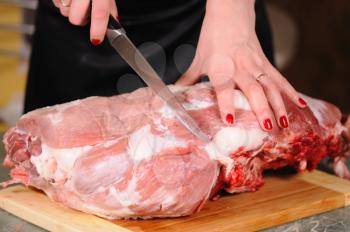 Royalty Free Photo of a Woman Cutting Meat