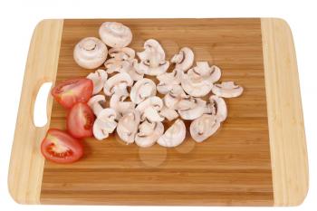mushrooms to cut on brown chopping board                                  