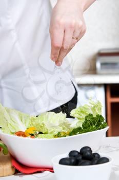 Royalty Free Photo of a Person Preparing a Salad