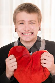 frustrated teenager  with a plush heart in hand