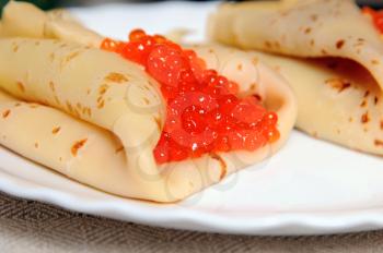 pancakes with red caviar on the plate