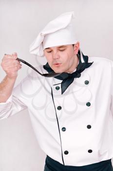 chef with large spoon on the gray background