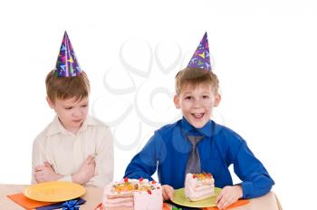 two boys eating a cake isolated on white background