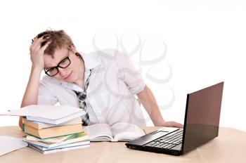 frustrated student sits behind a desk isolated on white background