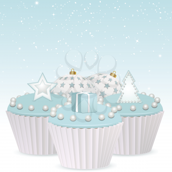 Blue Christmas cupcakes decorated with a present, star and Christmas tree on a blue background with buables