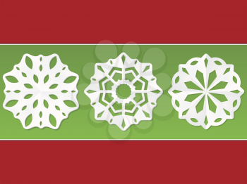 Christmas paper snowflakes on a green and red background