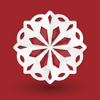 White paper snowflake on a red background