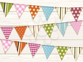Bunting with bright patterns on a white wood background