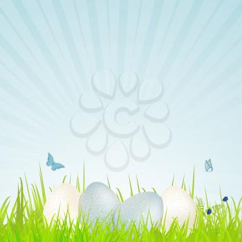 Easter Background with White and Blue Speckled Eggs on Grass