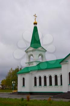 Royalty Free Photo of a Small Town Church With Gold Cupola