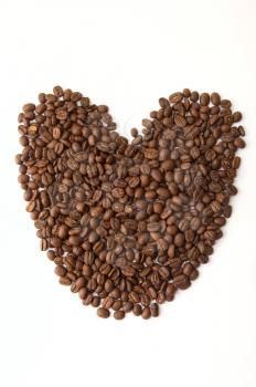 Coffee beans as heart on white background
