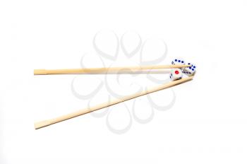 Chopsticks and dices on white background