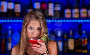Royalty Free Photo of a Woman Holding a Cocktail in a Club