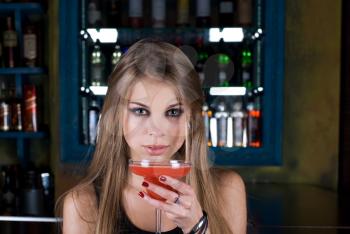 Royalty Free Photo of a Woman Holding a Cocktail in a Club