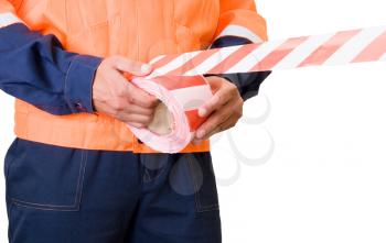 Royalty Free Photo of a Worker Putting up Warning Tape