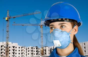 Royalty Free Photo of a Female Builder Wearing a Mask and Hardhat