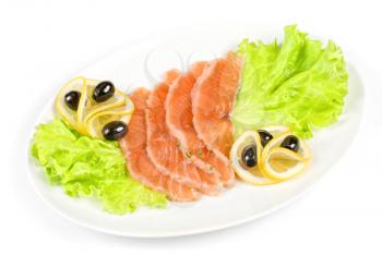 Salmon closeup with lettuce, lemon and olive on white background