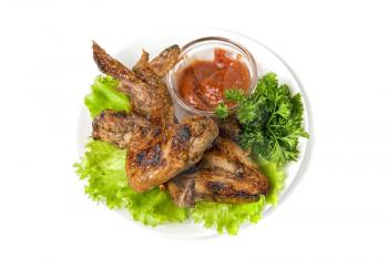 fried chicken wings with vegetables and sauce
