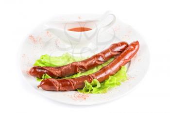 grilled sausage with lettuce and sauce isolated on white